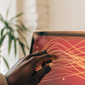 A human hand interacting with a glowing, holographic screen displaying abstract orange and yellow data visualizations, symbolizing human guidance over AI in financial decision-making.